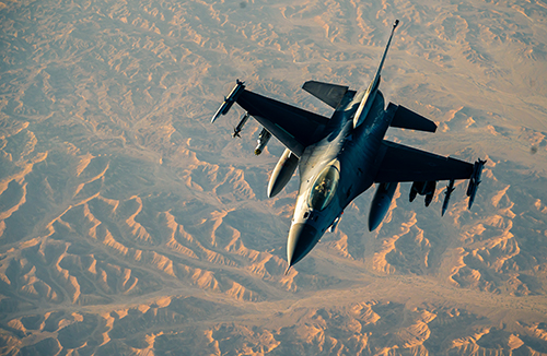 An image of a fighter aircraft over desert